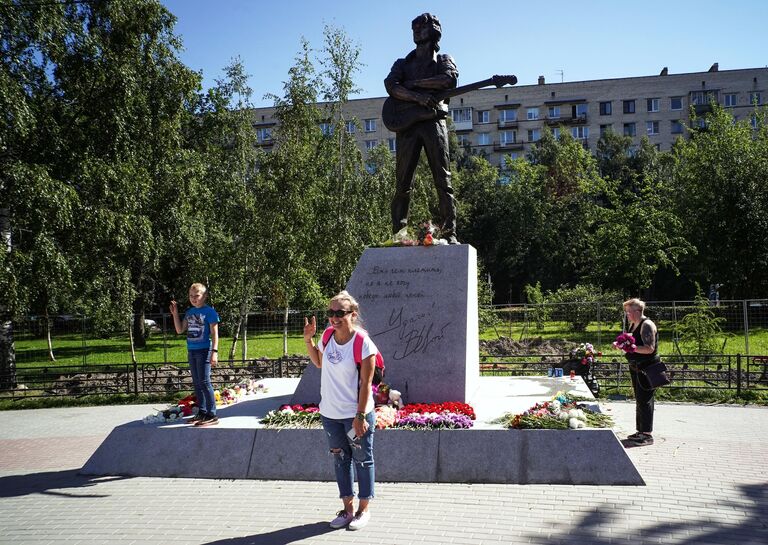 Люди у памятника лидеру группы Кино Виктору Цою скульптора Матвея Макушкина в Санкт-Петербурге