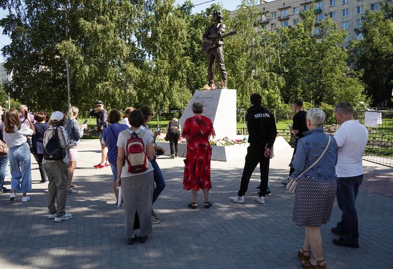 Люди у памятника лидеру группы Кино Виктору Цою скульптора Матвея Макушкина в Санкт-Петербурге