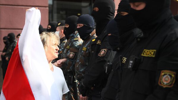 Сотрудники правоохранительных органов и участница акции протеста в Минске