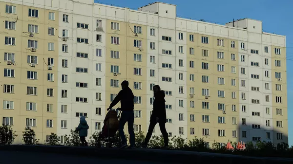 Семья на прогулке во дворе жилого дома