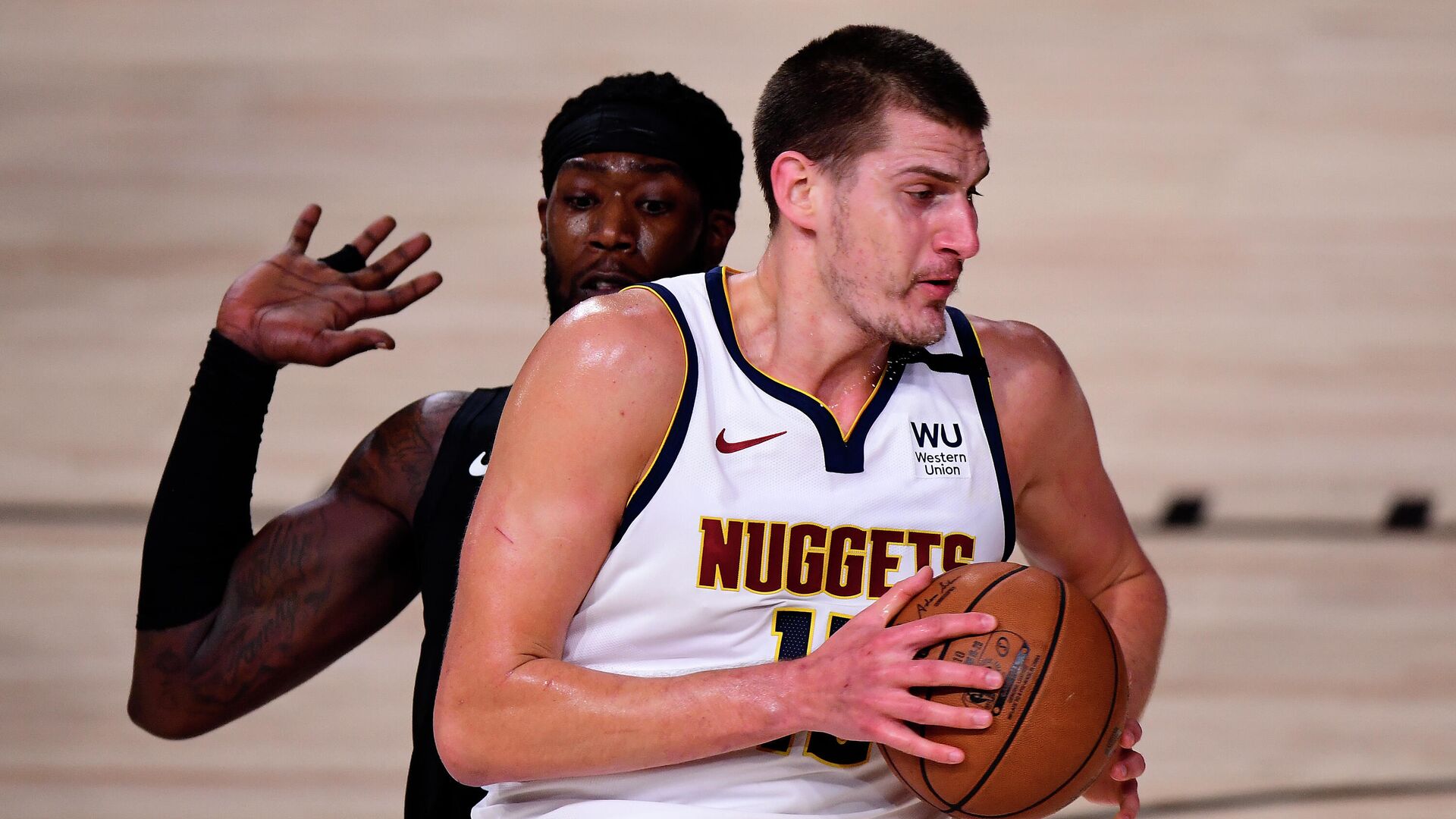 LAKE BUENA VISTA, FLORIDA - SEPTEMBER 15: Nikola Jokic #15 of the Denver Nuggets drives the ball against Montrezl Harrell #5 of the LA Clippers during the first quarter in Game Seven of the Western Conference Second Round during the 2020 NBA Playoffs at AdventHealth Arena at the ESPN Wide World Of Sports Complex on September 15, 2020 in Lake Buena Vista, Florida. NOTE TO USER: User expressly acknowledges and agrees that, by downloading and or using this photograph, User is consenting to the terms and conditions of the Getty Images License Agreement.   Douglas P. DeFelice/Getty Images/AFP - РИА Новости, 1920, 16.09.2020