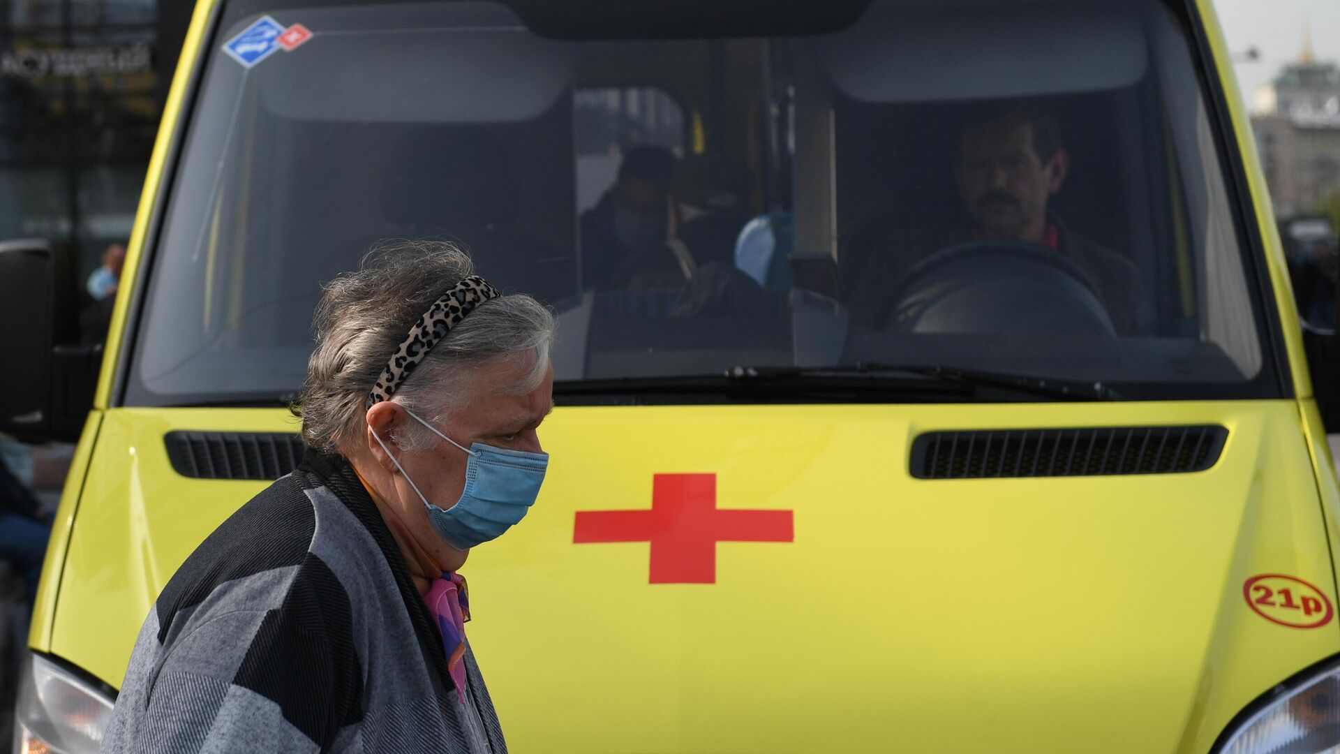 Пожилая женщина в медицинской маске у автомобиля скорой помощи на улице в Москве - РИА Новости, 1920, 29.09.2020