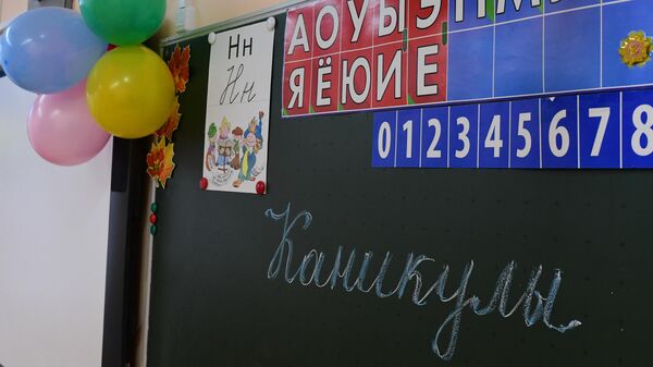 Надпись Каникулы на школьной доске в учебном классе в московской школе № 2127