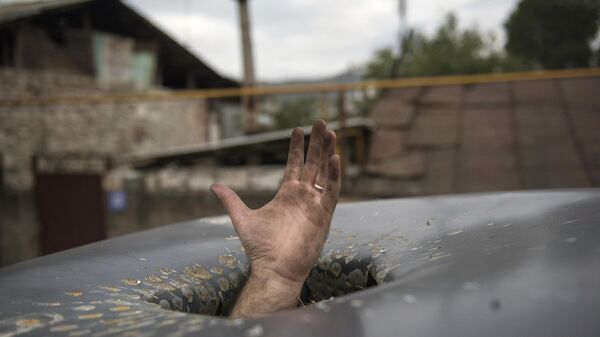 Пробоина в крыше автомобиля, появившаяся в результате обстрелов Степанакерта в Нагорном Карабахе