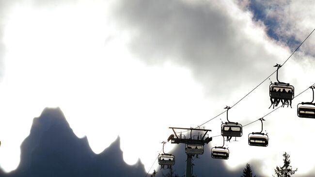 A picture shows the Dolomiti mountains behind clouds during the Freestyle world cup Ski Cross in San Candido on December 21, 2013.  AFP PHOTO/ VINCENZO PINTO (Photo by VINCENZO PINTO / AFP)