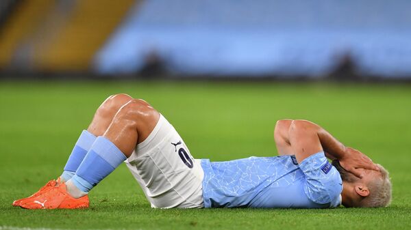 Manchester City's Argentinian striker Sergio Aguero reacts after picking up an injury during the UEFA Champions League football Group C match between Manchester City and Porto at the Etihad Stadium in Manchester, north west England on October 21, 2020. (Photo by Paul ELLIS / POOL / AFP)