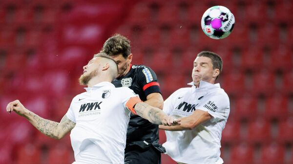 Leverkusen's Italian forward Lucas Alario (M), Augsburg's Dutch defender Jeffrey Gouweleeuw (L) and Augsburg's German defender Raphael Framberger vie for the ball during the German first division Bundesliga football match Bayer 04 Leverkusen v FC Augsburg, in Leverkusen, western Germany, on October 26, 2020. (Photo by Rolf Vennenbernd / POOL / AFP) / DFL REGULATIONS PROHIBIT ANY USE OF PHOTOGRAPHS AS IMAGE SEQUENCES AND/OR QUASI-VIDEO