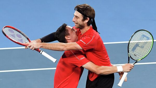 Joran Vliegen (L) and Sander Gille (R) of Belgium celebrate winning their men's doubles match against Grigor Dimitrov and Dimitar Kuzmanov of Bulgaria at the ATP Cup tennis tournament in Sydney on January 8, 2020. (Photo by William WEST / AFP) / -- IMAGE RESTRICTED TO EDITORIAL USE - STRICTLY NO COMMERCIAL USE --