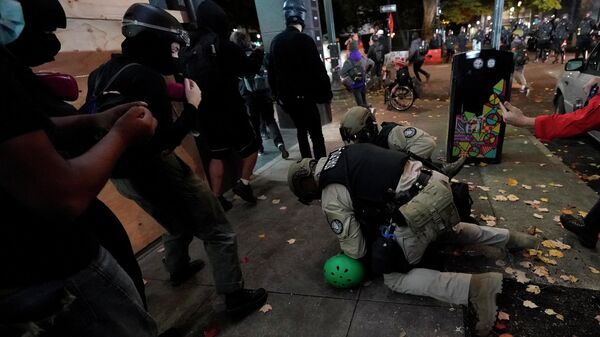 Полицейские задерживают протестующего в Портленде, штат Орегон, США
