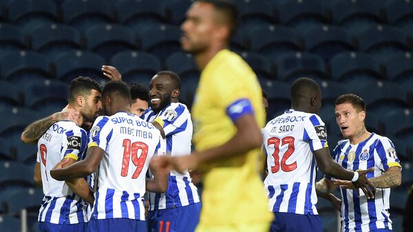 Porto's players celebrate after Porto's Iranian forward Mehdi Taremi (L) scored a goal during the Portuguese League football match between Porto and Portimonense at the Dragao stadium in Porto on November 8, 2020. (Photo by MIGUEL RIOPA / AFP)