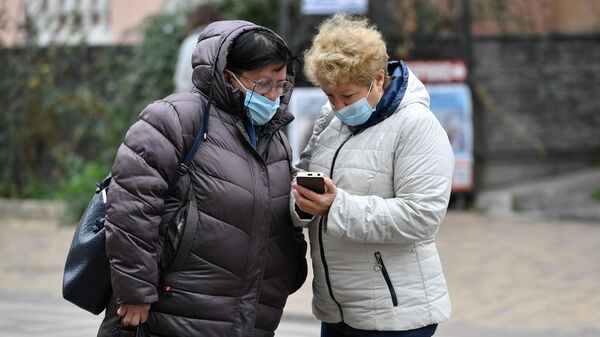 Женщины в медицинских масках на одной из улиц в Симферополе