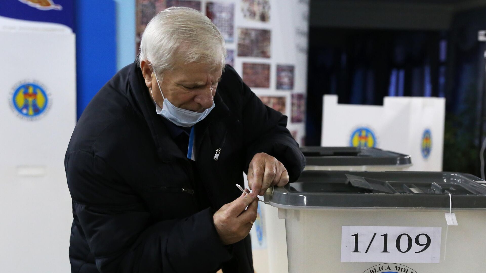 Член избирательной комиссии пломбирует избирательную урну на избирательном участке в Кишиневе - РИА Новости, 1920, 15.11.2020