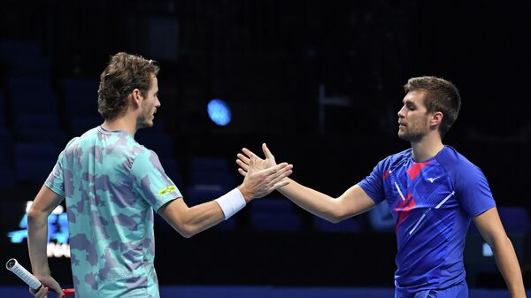 Croatia's Nikola Mektic (R) and Netherlands' Wesley Koolhof (L) celebrate after beating USA's Rajeev Ram and Britain's Joe Salisbury in their men's doubles round-robin match on day three of the ATP World Tour Finals tennis tournament at the O2 Arena in London on November 17, 2020. (Photo by Glyn KIRK / AFP)
