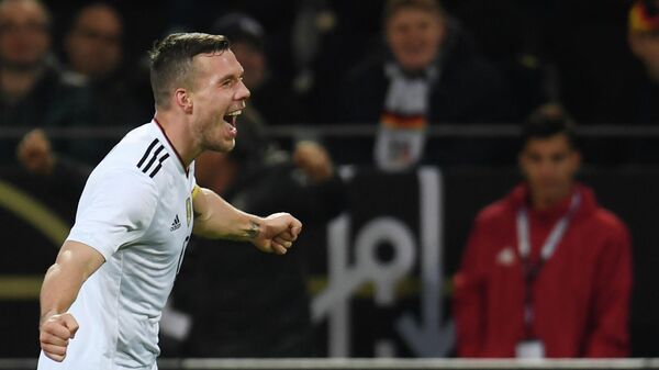 Germany's midfielder Lukas Podolski celebrates after scoring during a friendly football match between Germany and England on March 22, 2017 in Dortmund, western Germany. - It is Lukas Podolski's last match with the German team. (Photo by PATRIK STOLLARZ / AFP)