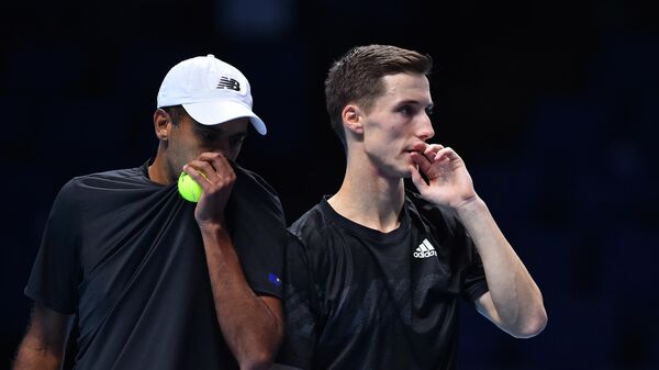 USA's Rajeev Ram (L) talks with Britain's Joe Salisbury (R) as they play against Netherlands' Wesley Koolhof and Croatia's Nikola Mektic in their men's doubles round-robin match on day three of the ATP World Tour Finals tennis tournament at the O2 Arena in London on November 17, 2020. (Photo by Glyn KIRK / AFP)
