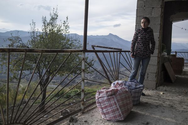 Женщина возле дома в поселке Карегах в Нагорном Карабахе