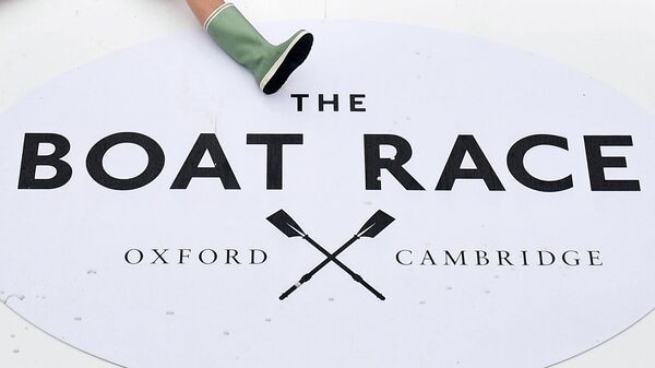 Beside the branding, members of all the Cambridge boat crews celebrate together after Cambridge win all the races on the day of the 165th annual men's boat race between Oxford University and Cambridge University on the River Thames in London on April 7, 2019. (Photo by Daniel LEAL-OLIVAS / AFP)
