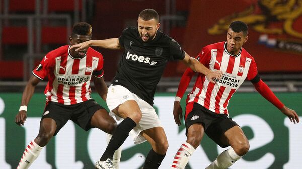 PAOK FC's Belgian midfielder Omar El Kaddouri (C) fights for the ball with PSV Eindhoven's Ivorian midfielder Ibrahim Sangare (L) and PSV Eindhoven's Dutch forward Cody Gakpo (R) during the UEFA Europa League group E football match between PSV Eindhoven and PAOK FC Saloniki at the PSV stadium on November 26, 2020 in Eindhoven. (Photo by Olaf KRAAK / ANP / AFP) / Netherlands OUT