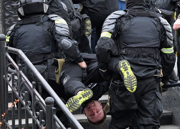 Сотрудники правоохранительных органов задерживают участника несанкционированной акции протеста Марш народовластия в Минске