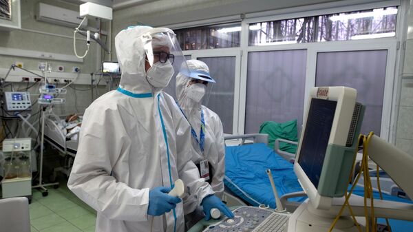 Врачи у аппарата УЗИ в отделении реанимации и интенсивной терапии в госпитале COVID-19 в городской клинической больнице № 52 в Москве