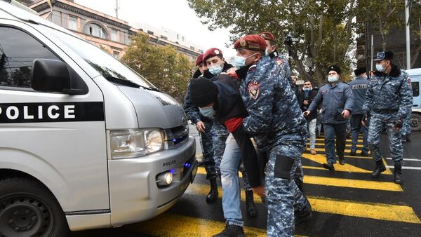 Сотрудники правоохранительных органов задерживают участника акции протеста против действующего правительства в Ереване