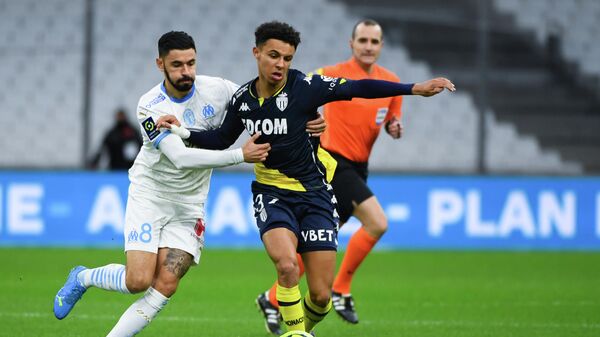 Monaco’s French midfielder Sofiane Diop (C) vies with Marseille's French midfielder Morgan Sanson during the French L1 football match between Olympique de Marseille (OM) and AS Monaco at the Velodrome Stadium in Marseille, southeastern France, on December 12, 2020. (Photo by CLEMENT MAHOUDEAU / AFP)
