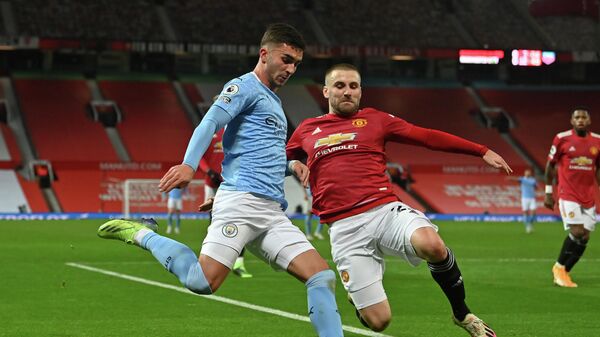 Manchester City's Spanish midfielder Ferran Torres (L) vies with Manchester United's English defender Luke Shaw (R) during the English Premier League football match between Manchester United and Manchester City at Old Trafford in Manchester, north west England, on December 12, 2020. (Photo by Paul ELLIS / POOL / AFP) / RESTRICTED TO EDITORIAL USE. No use with unauthorized audio, video, data, fixture lists, club/league logos or 'live' services. Online in-match use limited to 120 images. An additional 40 images may be used in extra time. No video emulation. Social media in-match use limited to 120 images. An additional 40 images may be used in extra time. No use in betting publications, games or single club/league/player publications. / 