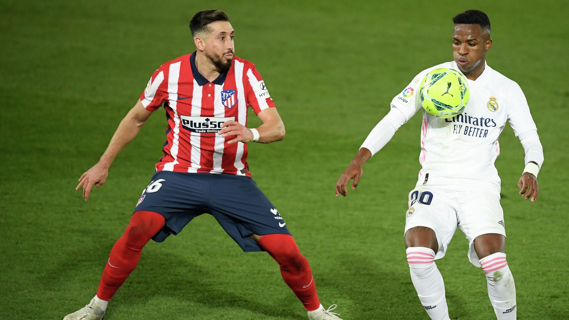 Atletico Madrid's Mexican midfielder Hector Herrera (L) vies with Real Madrid's Brazilian forward Vinicius Junior during the Spanish league football match between Real Madrid CF and Club Atletico de Madrid at the Alfredo di Stefano stadium in Madrid on December 12, 2020. (Photo by OSCAR DEL POZO / AFP) / “The erroneous mention[s] appearing in the metadata of this photo by OSCAR DEL POZO has been modified in AFP systems in the following manner: [Atletico Madrid's Mexican midfielder Hector Herrera] instead of [Atletico Madrid's Argentine forward Angel Correa]. Please immediately remove the erroneous mention[s] from all your online services and delete it (them) from your servers. If you have been authorized by AFP to distribute it (them) to third parties, please ensure that the same actions are carried out by them. Failure to promptly comply with these instructions will entail liability on your part for any continued or post notification usage. Therefore we thank you very much for all your attention and prompt action. We are sorry for the inconvenience this notification may cause and remain at your disposal for any further information you may require.” - РИА Новости, 1920, 13.12.2020