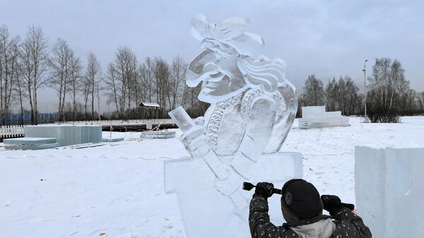 Скульптор во время создания ледяной фигуры