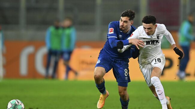 Augsburg's Swiss midfielder Ruben Vargas (R) and Schalke's German midfielder Suat Serdar vie for the ball during the German first division football Bundesliga match FC Augsburg 1907 vs FC Schalke 04 in Augsburg, southern Germany, on December 13, 2020. (Photo by Christof STACHE / various sources / AFP) / DFL REGULATIONS PROHIBIT ANY USE OF PHOTOGRAPHS AS IMAGE SEQUENCES AND/OR QUASI-VIDEO