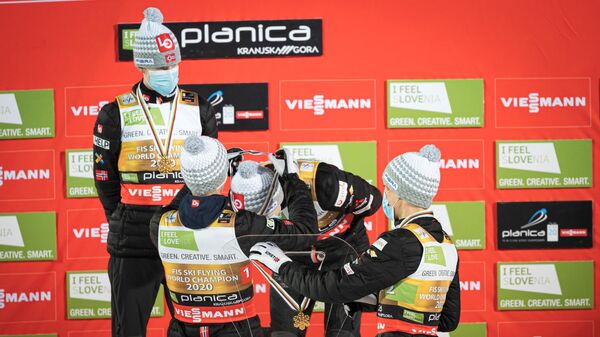 (From L) Robert Johansson, Daniel Andre Tande, Halvor Egner Granerud and Johann Andre Forfang of Norway take the gold medals after winning the Flying Hill Team event of the FIS Ski Flying World Championship in Planica, on December 13, 2020. (Photo by Jure Makovec / AFP)