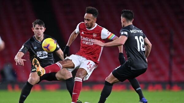 Arsenal's Gabonese striker Pierre-Emerick Aubameyang (C) controls the ball in front of Burnley's English defender James Tarkowski (L) and Burnley's English midfielder Ashley Westwood (R) during the English Premier League football match between Arsenal and Burnley at the Emirates Stadium in London on December 13, 2020. (Photo by Laurence Griffiths / POOL / AFP) / RESTRICTED TO EDITORIAL USE. No use with unauthorized audio, video, data, fixture lists, club/league logos or 'live' services. Online in-match use limited to 120 images. An additional 40 images may be used in extra time. No video emulation. Social media in-match use limited to 120 images. An additional 40 images may be used in extra time. No use in betting publications, games or single club/league/player publications. / 