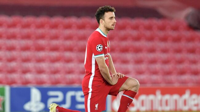 Liverpool's Portuguese striker Diogo Jota 'takes a knee' in support of anti-Racism campaigns ahead of the UEFA Champions League 1st round Group D football match between Liverpool and Ajax at Anfield  in Liverpool, north west England on December 1, 2020. (Photo by Paul ELLIS / POOL / AFP)