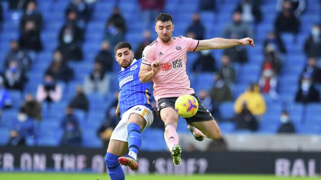 Soccer Football - Premier League - Brighton & Hove Albion v Sheffield United - The American Express Community Stadium, Brighton, Britain - December 20, 2020  Brighton & Hove Albion's Alireza Jahanbakhsh in action with Sheffield United's Enda Stevens Pool via REUTERS/Glyn Kirk EDITORIAL USE ONLY. No use with unauthorized audio, video, data, fixture lists, club/league logos or 'live' services. Online in-match use limited to 75 images, no video emulation. No use in betting, games or single club /league/player publications.  Please contact your account representative for further details.