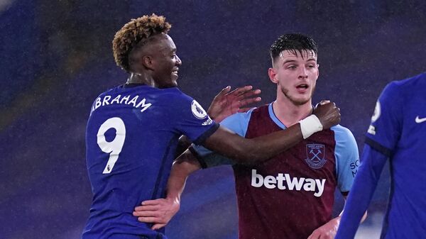 Chelsea's English striker Tammy Abraham (L) speaks with West Ham United's English midfielder Declan Rice (R) on the pitch after the English Premier League football match between Chelsea and West Ham United at Stamford Bridge in London on December 21, 2020. - Chelsea won the game 3-0. (Photo by John Walton / POOL / AFP) / RESTRICTED TO EDITORIAL USE. No use with unauthorized audio, video, data, fixture lists, club/league logos or 'live' services. Online in-match use limited to 120 images. An additional 40 images may be used in extra time. No video emulation. Social media in-match use limited to 120 images. An additional 40 images may be used in extra time. No use in betting publications, games or single club/league/player publications. / 