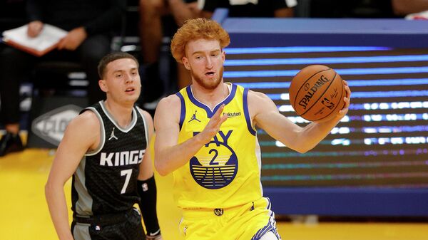 SAN FRANCISCO, CALIFORNIA - JANUARY 04: Nico Mannion #2 of the Golden State Warriors dribbles past Kyle Guy #7 of the Sacramento Kings at Chase Center on January 04, 2021 in San Francisco, California. NOTE TO USER: User expressly acknowledges and agrees that, by downloading and or using this photograph, User is consenting to the terms and conditions of the Getty Images License Agreement.   Ezra Shaw/Getty Images/AFP