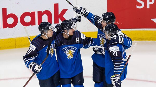 EDMONTON, AB - DECEMBER 25: Kasper Puutio #10, Mikko Kokkonen #35, Henri Nikkanen #28 and Mikael Pyyhtia #21 of Finland celebrate a goal against Germany during the 2021 IIHF World Junior Championship at Rogers Place on December 25, 2020 in Edmonton, Canada.   Codie McLachlan/Getty Images/AFP