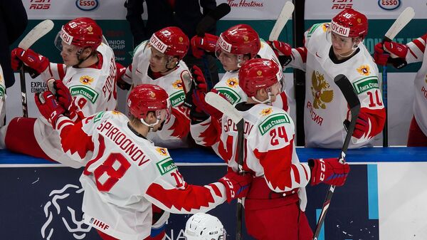 EDMONTON, AB - JANUARY 05: Ilya Safonov #24 and Yegor Spiridonov #18 of Russia celebrate a goal against Finland during the 2021 IIHF World Junior Championship bronze medal game at Rogers Place on January 5, 2021 in Edmonton, Canada.   Codie McLachlan/Getty Images/AFP