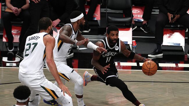 NEW YORK, NEW YORK - JANUARY 05: Kyrie Irving #11 of the Brooklyn Nets drives against the Utah Jazz during their game at Barclays Center on January 05, 2021 in New York City. NOTE TO USER: User expressly acknowledges and agrees that, by downloading and/or using this Photograph, user is consenting to the terms and conditions of the Getty Images License Agreement.   Al Bello/Getty Images/AFP