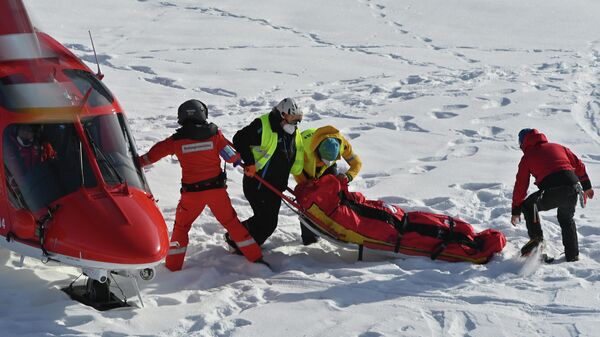 Спасатели несут американского горнолыжника Томми Форда к вертолету