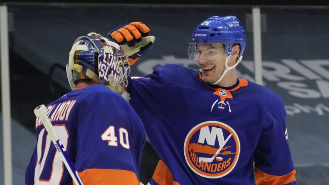 UNIONDALE, NEW YORK - JANUARY 18: Semyon Varlamov #40 and Scott Mayfield #24 of the New York Islanders celebrate a 1-0 shutout against the Boston Bruins at the Nassau Coliseum on January 18, 2021 in Uniondale, New York.   Bruce Bennett/Getty Images/AFP