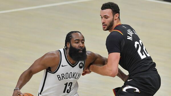 CLEVELAND, OHIO - JANUARY 20: James Harden #13 of the Brooklyn Nets drives around Larry Nance Jr. #22 of the Cleveland Cavaliers during the third quarter at Rocket Mortgage Fieldhouse on January 20, 2021 in Cleveland, Ohio. NOTE TO USER: User expressly acknowledges and agrees that, by downloading and/or using this photograph, user is consenting to the terms and conditions of the Getty Images License Agreement.   Jason Miller/Getty Images/AFP