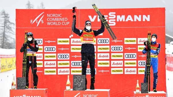 (L to R) Second placed Japan's Akito Watabe, winner Norway's Jarl Magnus Riiber and third placed Finland's Ilkka Herola celebrate on the podium after the Men's Gundersen Normal Hill 10km event of the FIS Nordic Combined World Cup in Seefeld, Austria, on January 30, 2021. (Photo by BARBARA GINDL / APA / AFP) / Austria OUT