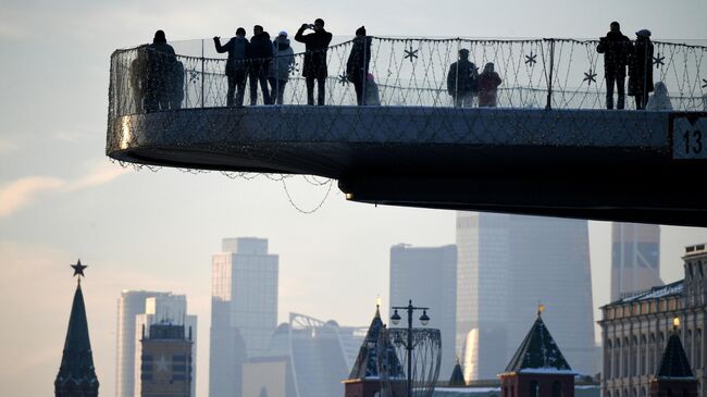 Отдыхающие на смотровой площадке в парке Зарядье в Москве.