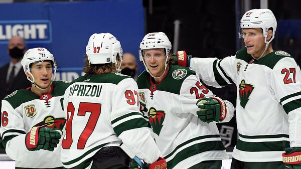 LOS ANGELES, CALIFORNIA - JANUARY 14: Jonas Brodin #25 of the Minnesota Wild celebrates his goal with Jared Spurgeon #46, Kirill Kaprizov #97 and Nick Bjugstad #27 of the Minnesota Wild, to take a 1-0 lead, during the first period in the season opening game at Staples Center on January 14, 2021 in Los Angeles, California.   Harry How/Getty Images/AFP