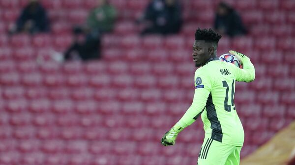 Ajax's Cameroon goalkeeper Andre Onana throws the ball during the UEFA Champions League 1st round Group D football match between Liverpool and Ajax at Anfield  in Liverpool, north west England on December 1, 2020. (Photo by Jon Super / POOL / AFP)