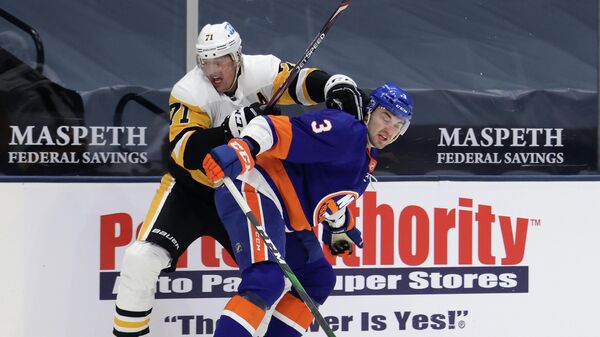 UNIONDALE, NEW YORK - FEBRUARY 06: Evgeni Malkin #71 of the Pittsburgh Penguins attempts to get past Adam Pelech #3 of the New York Islanders during the first period at the Nassau Coliseum on February 06, 2021 in Uniondale, New York.   Bruce Bennett/Getty Images/AFP