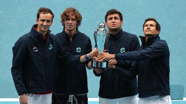 Tennis - ATP Cup - Melbourne Park, Melbourne, Australia, February 7, 2021 Russia's Daniil Medvedev, Andrey Rublev, Aslan Karatsev and Evgeny Donskoy celebrate winning the ATP Cup with the trophy after their final against Italy REUTERS/Asanka Brendon Ratnayake