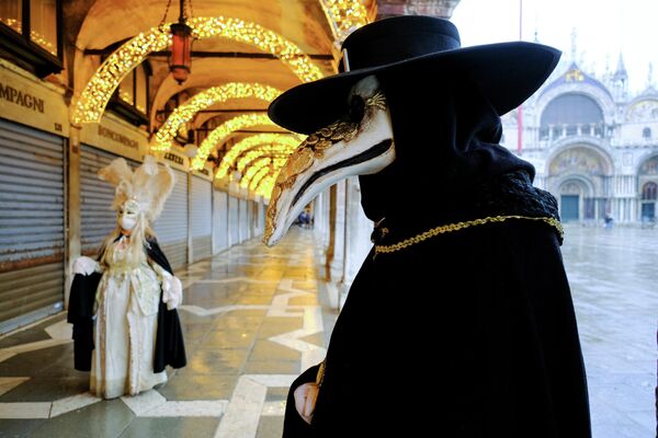 Люди в карнавальных масках и костюмах во время ежегодного Венецианского карнавала, который был отменен в этом году из-за пандемии коронавирусной инфекции в Венеции, Италия 
