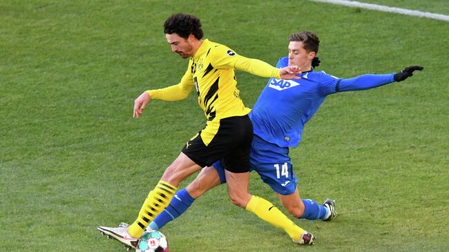 Hoffenheim's Austrian midfielder Christoph Baumgartner (R) and Dortmund's Danish midfielder Thomas Delaney vie for the ball during the German first division Bundesliga football match between Borussia Dortmund and TSG 1899 Hoffenheim in Dortmund, western Germany, on February 13, 2021. (Photo by Martin Meissner / POOL / AFP) / DFL REGULATIONS PROHIBIT ANY USE OF PHOTOGRAPHS AS IMAGE SEQUENCES AND/OR QUASI-VIDEO